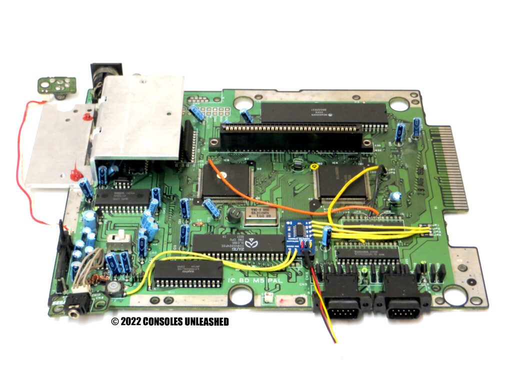 Full top side PCB showing Sega Mega Drive switchless region mod kit installed.