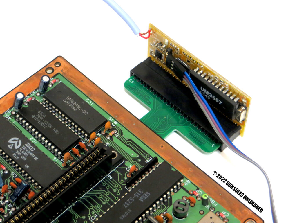 Top side of Sega Master System 2 FM Sound Module Adapter installed with attached FM Module.